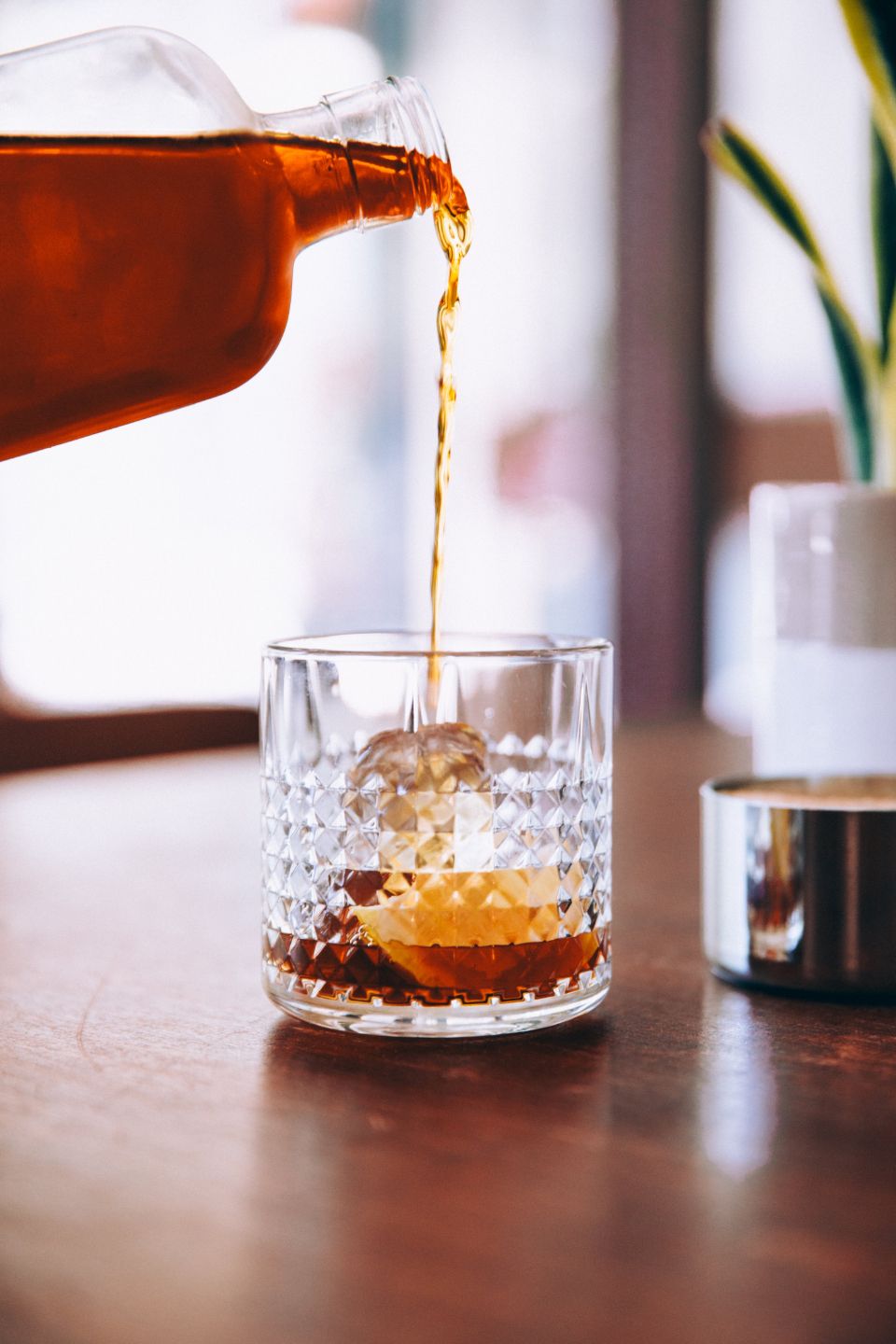 A cocktail being finished at the bar